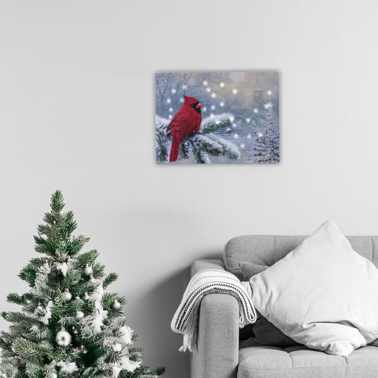 Canvas print of a red cardinal on a branch with snowflakes, displayed above a sofa and Christmas tree.