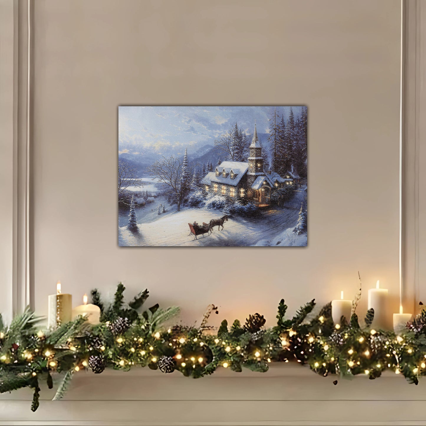 Wrapped-canvas winter scene above a decorated mantel with garland and candles.