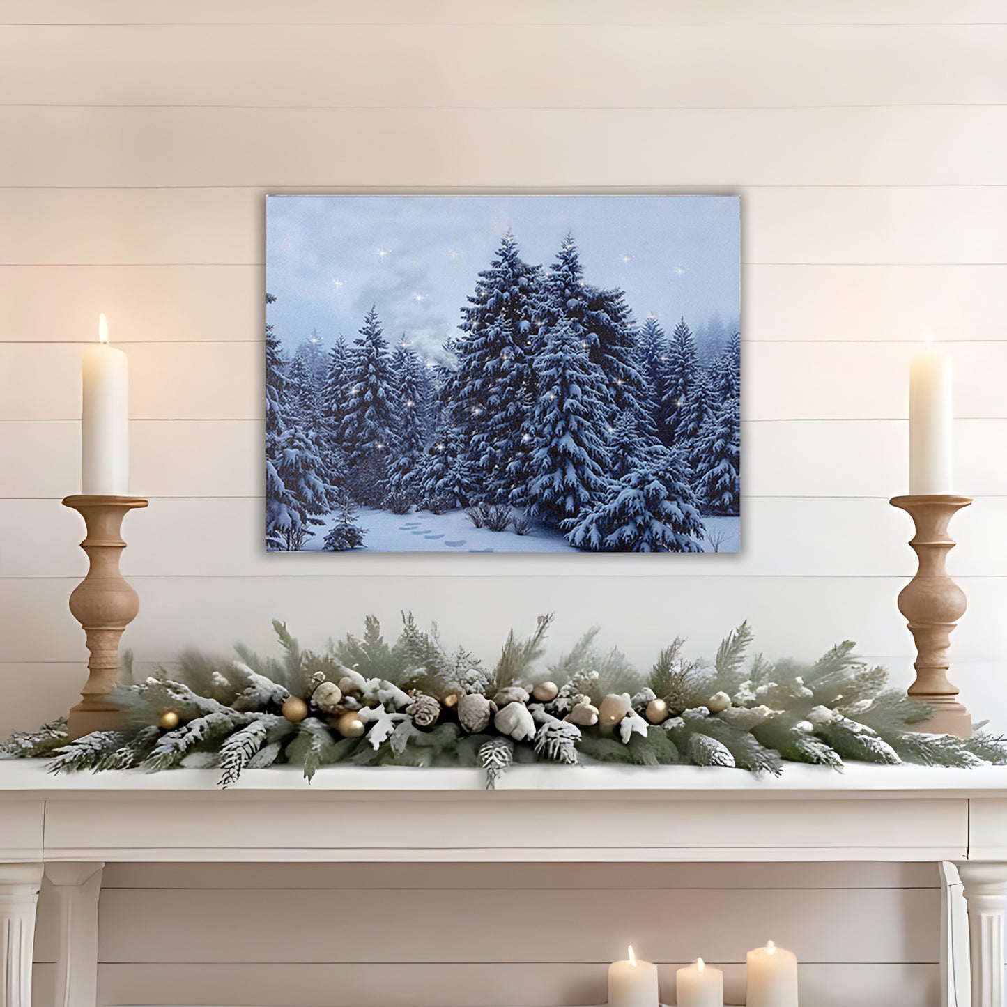 Festive mantel with winter scene canvas print, candles, and decorative garland.
