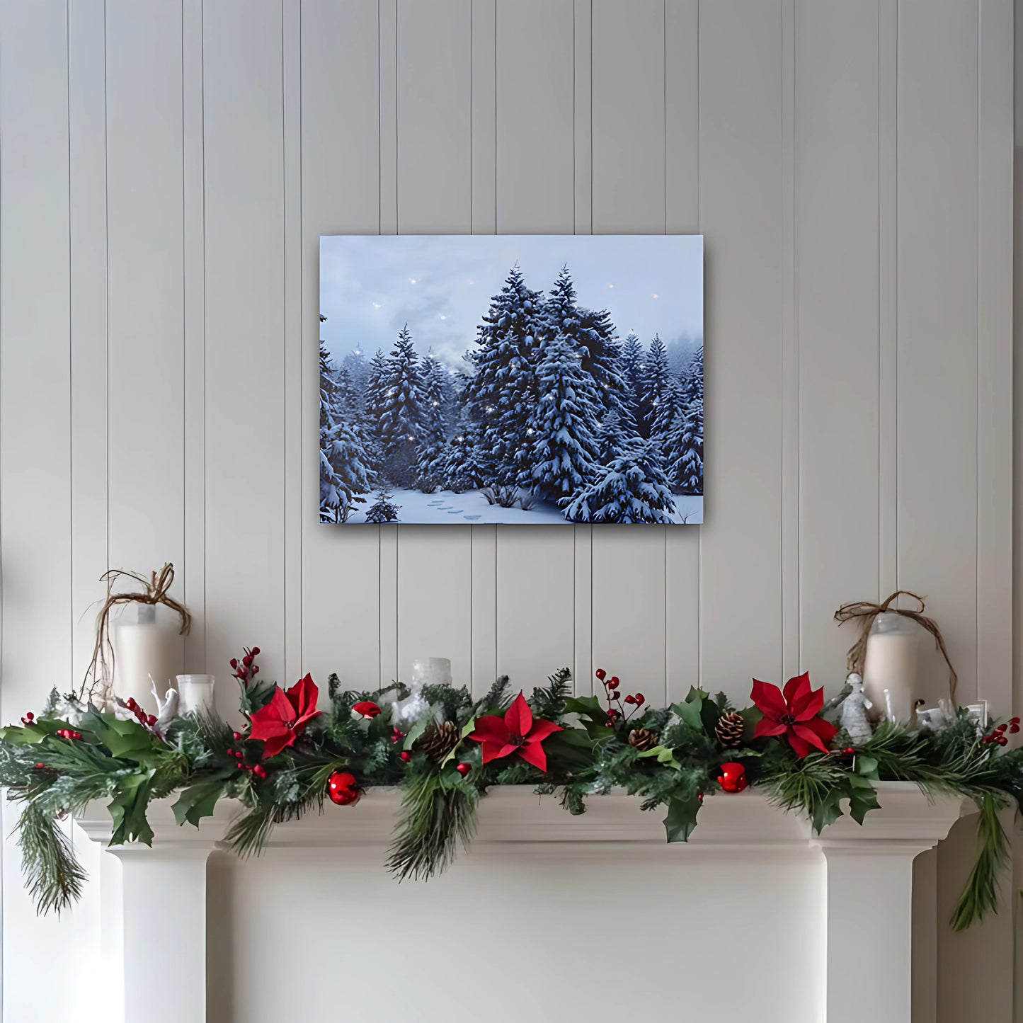 Decorative Christmas mantel with garland and candles against a wall with a snowy forest print.
