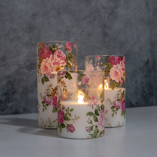 Set of three battery operated clear glass hurricane candles with a floral design, featuring a wax candle inside and an LED light visible through the glass.