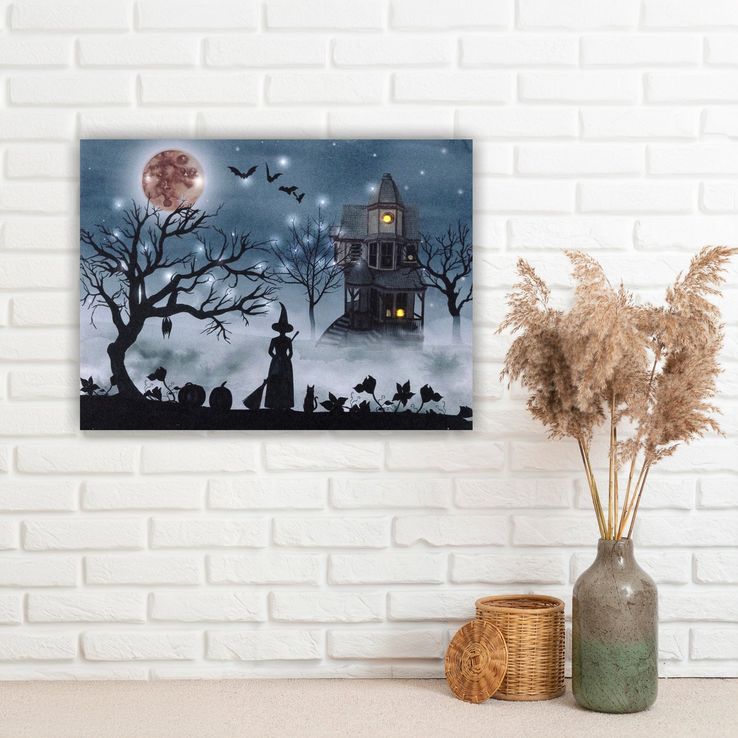 Halloween-themed wall art on a white brick wall with decorative elements.