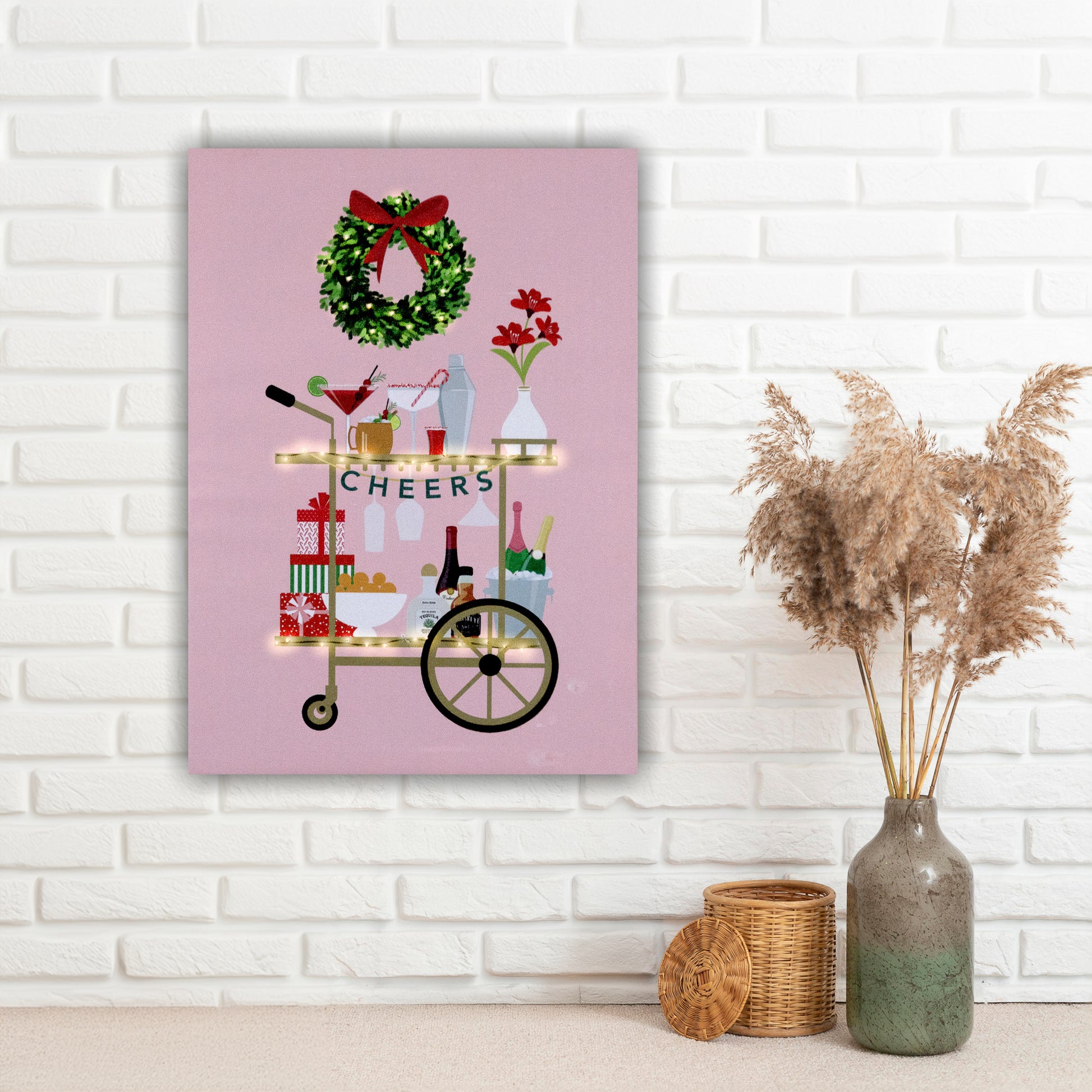 Decorative wall art with a Christmas theme on a pink background, featuring a bar cart, wreath, and presents.