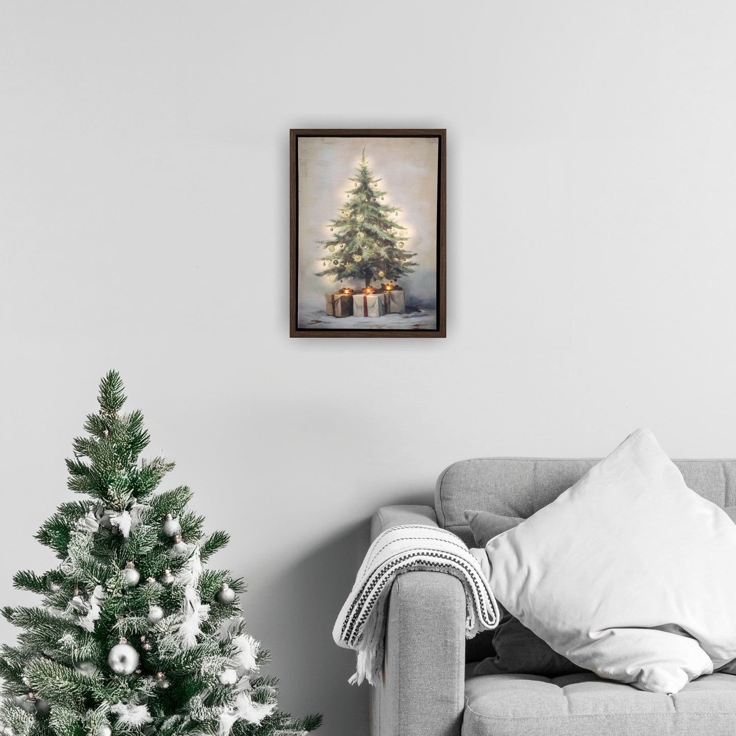 Framed artwork of a Christmas tree on a wall above a decorated tree and sofa.