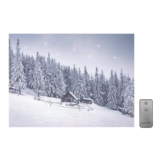 A canvas wall art featuring a snowy cabin with surrounding pine trees, illuminated by twinkling cool white LED lights. A remote control is also shown.