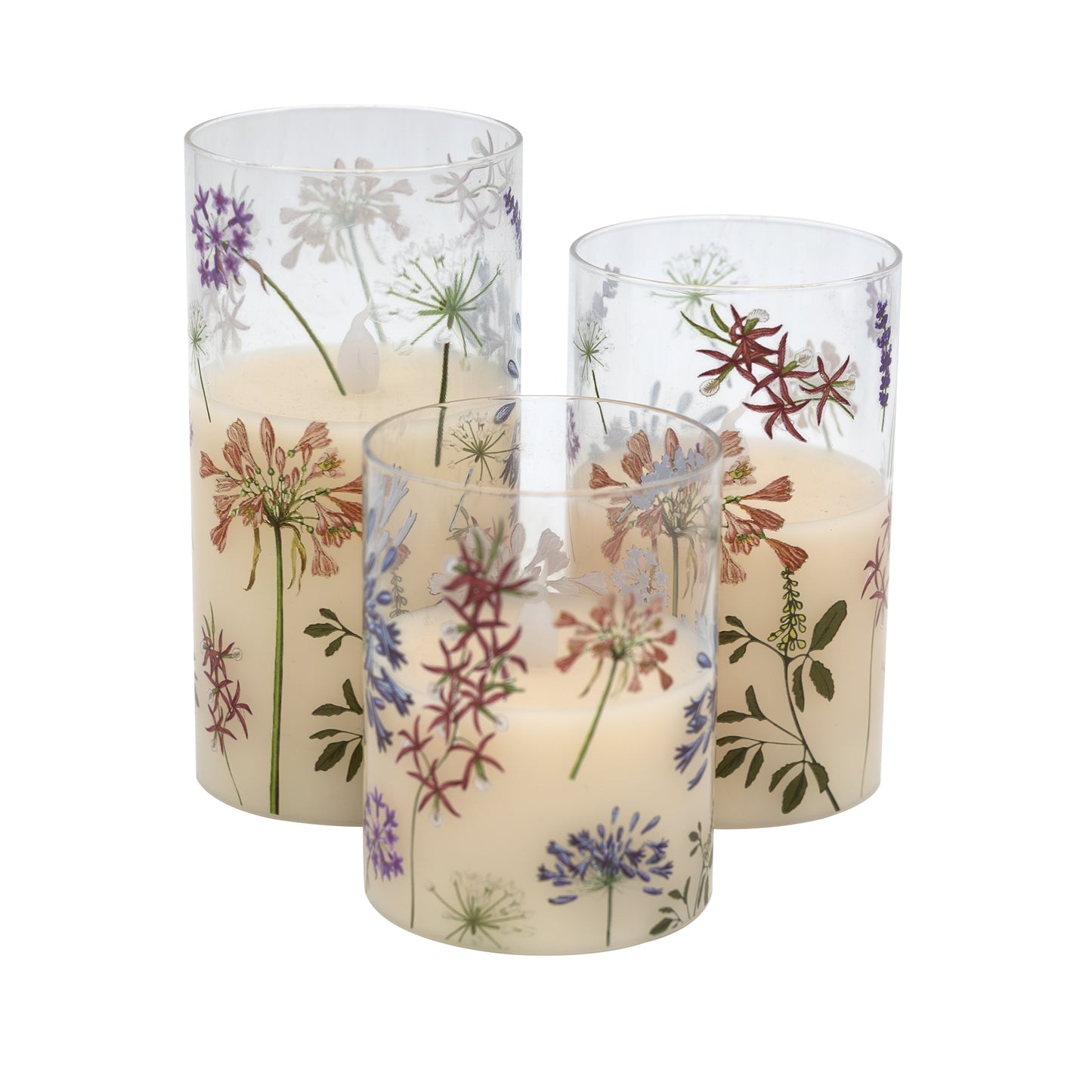 Set of three battery operated clear glass hurricane candles with a floral design, featuring a wax candle inside and an LED light visible through the glass.