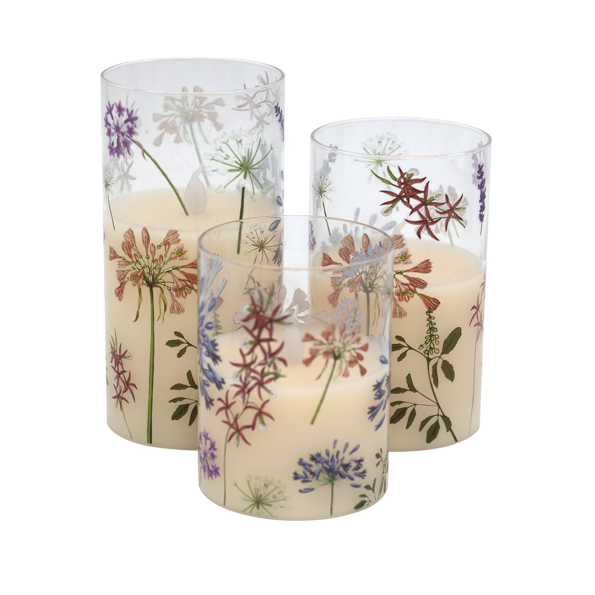 Set of three battery operated clear glass hurricane candles with a floral design, featuring a wax candle inside and an LED light visible through the glass.