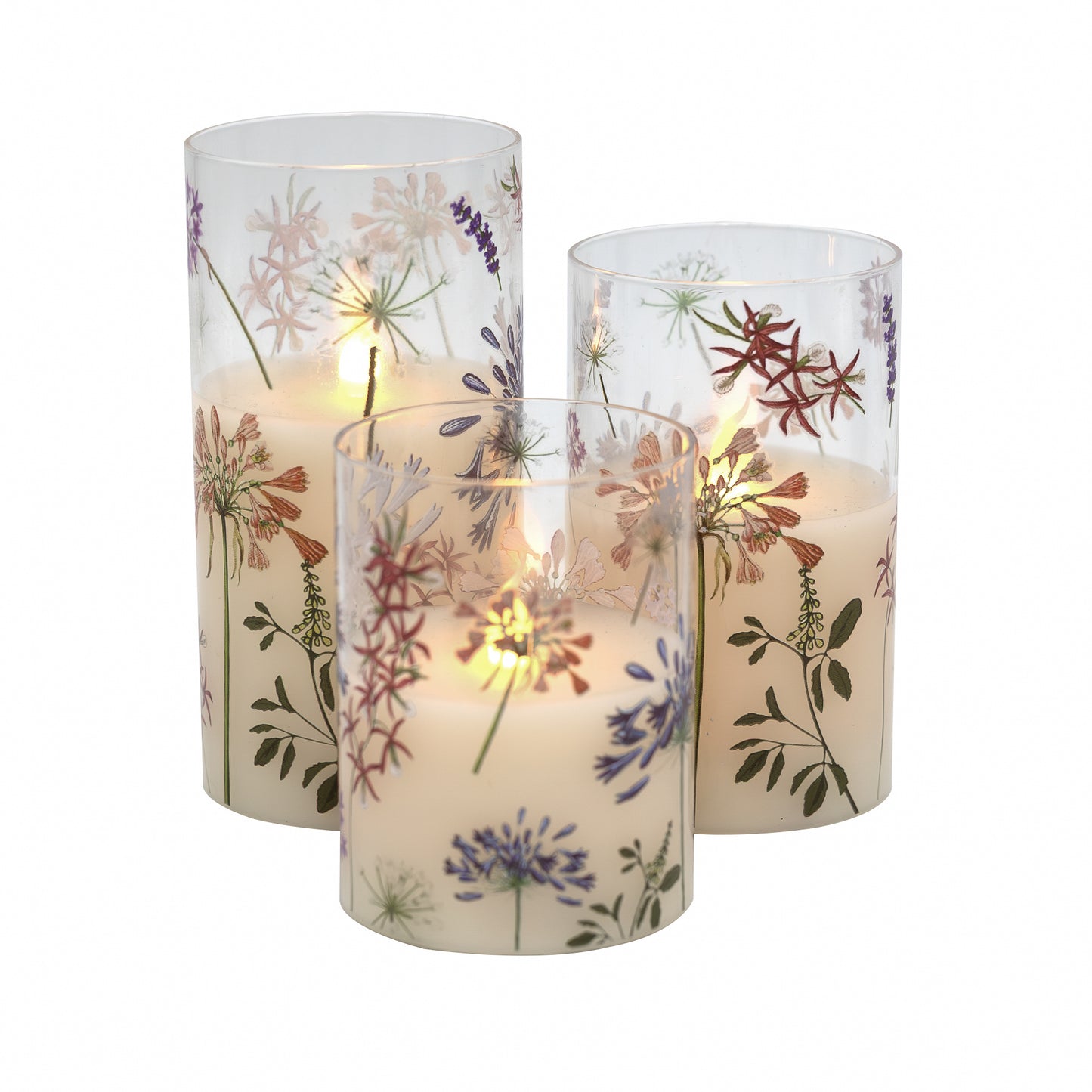 Set of three battery operated clear glass hurricane candles with a floral design, featuring a wax candle inside and an LED light visible through the glass.