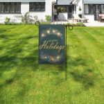 Holiday garden flag stand with LED lights and remote control in front lawn.