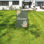 Lighted garden flag stand with remote control LED lights in front lawn.