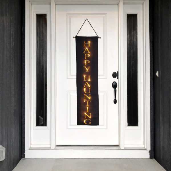 Halloween wall banner decor with remote control LED lights hanging on the front door.
