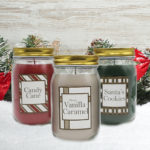 Christmas cookies candles set of 3 in the snow surrounded by holiday garland.