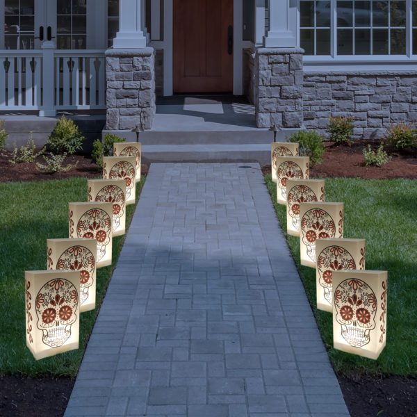 Halloween Luminary Bags, 12 plastic sugar skull luminaries line pathway in front of house.