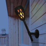 Solar Torch Lantern with Flame Effect in Backyard Deck as Torch Wall Sconce.