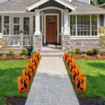 Halloween Luminaria Bags with Battery Operated Light and Witch Design Line the Front Home Pathway.