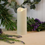 Pillar candle on table with plants