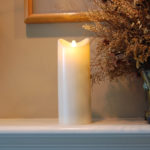 Battery operated candle on fireplace mantel