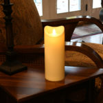 Pillar candle on night stand in living room